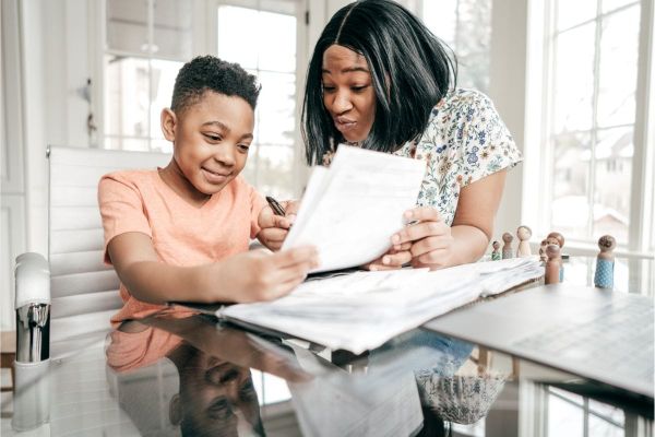 person helping child -  Best Homeschool Programs