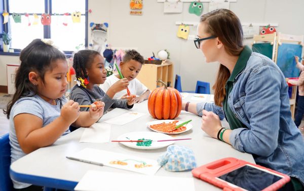teacher in class with pumpkin - Part-Time Preschool