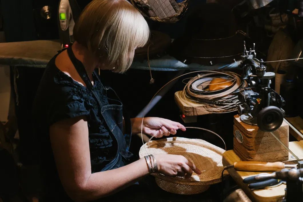 "Master milliner handcrafting a straw hat for Kentucky Derby millinery, showcasing traditional techniques and timeless hat-making artistry"