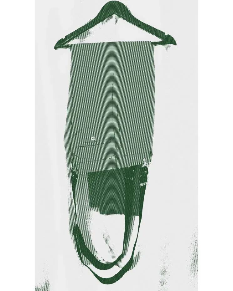 Pair of men’s trousers with button-on suspenders draped over a hanger – classic Derby Day style and guide to wearing suspenders.