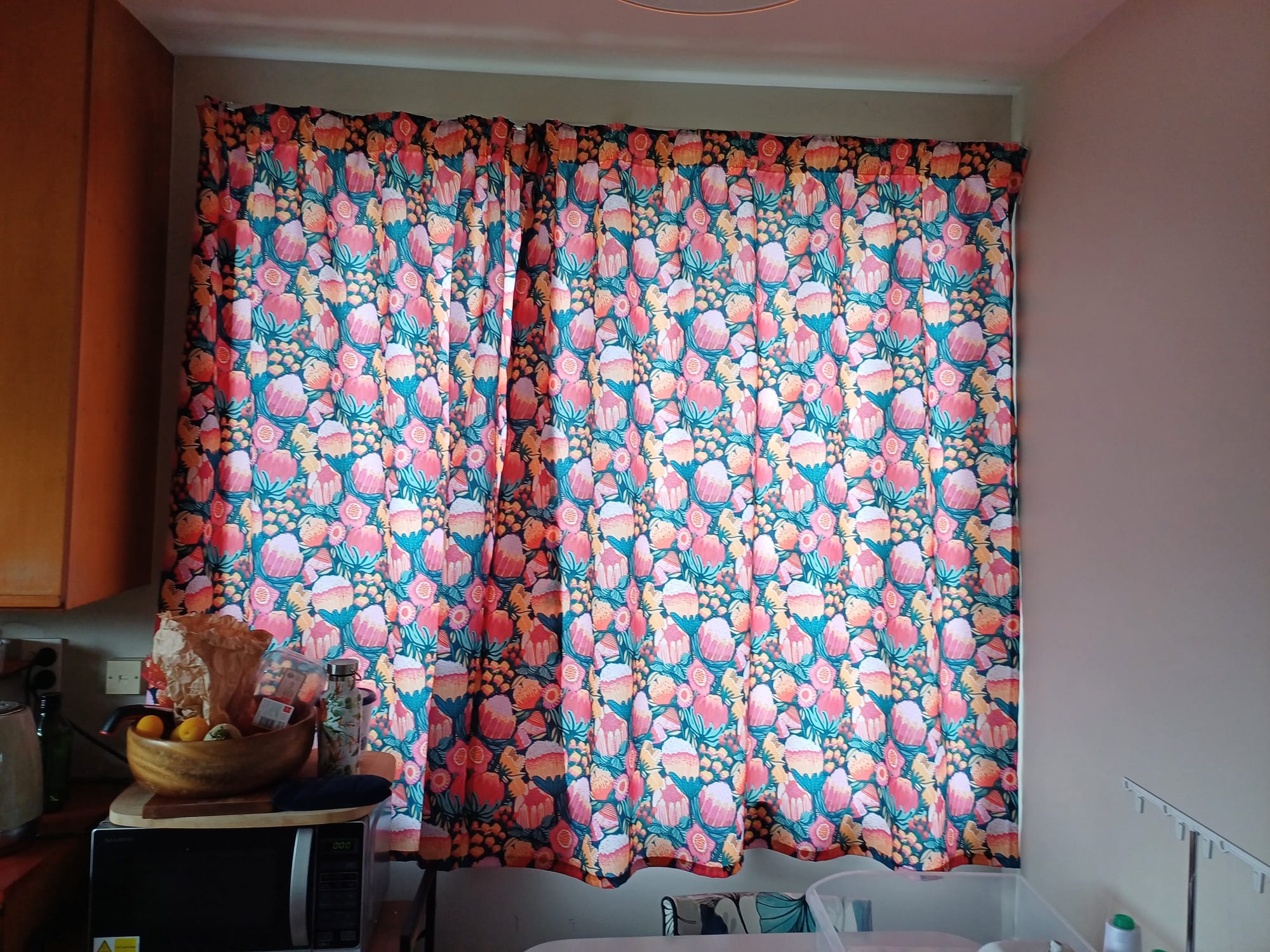 My new kitchen curtains, a hectic large floral print on a dark blue background with the sunlight glowing etherally through the fabric