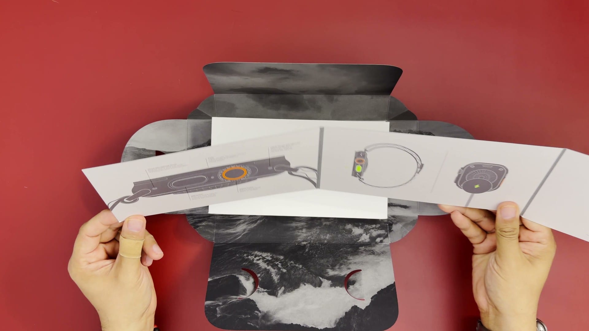 Apple Watch Ultra 4 button guide booklet unfolded over the opened box