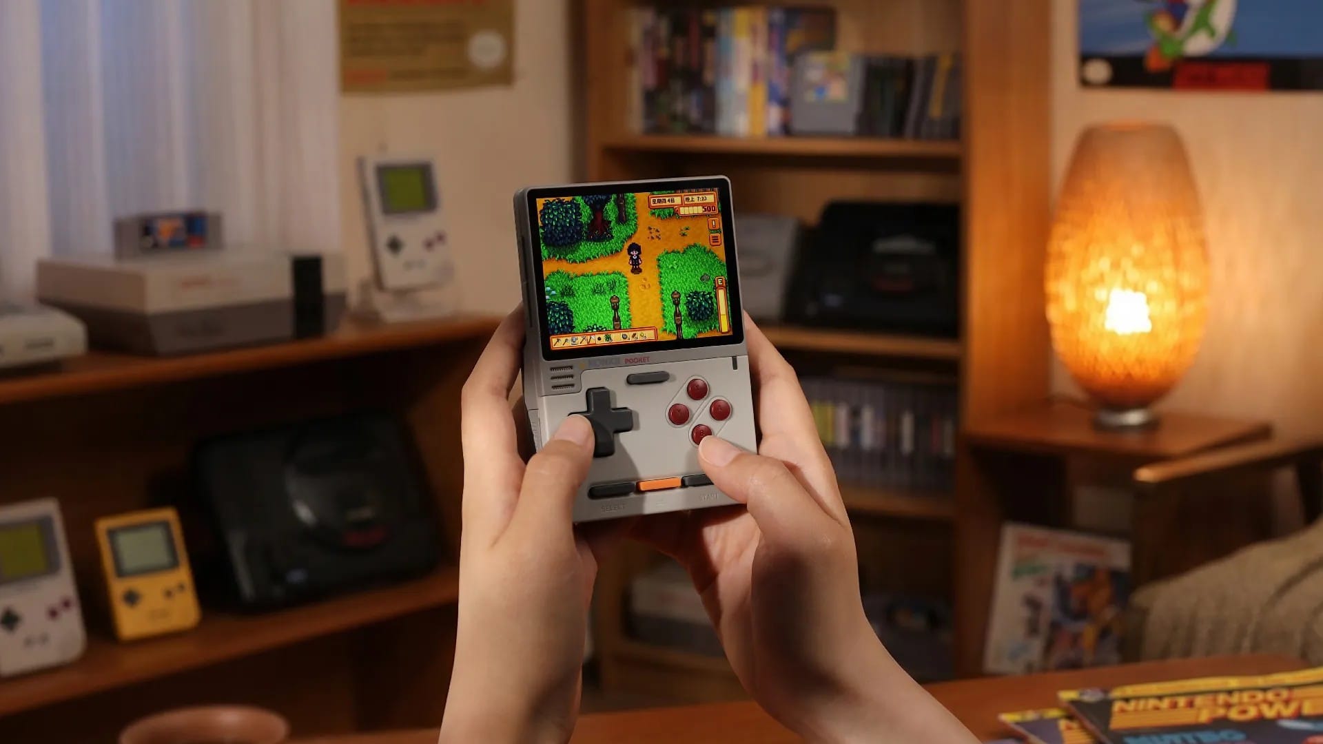 Person playing the KONKR Pocket Block in a room full of retro consoles