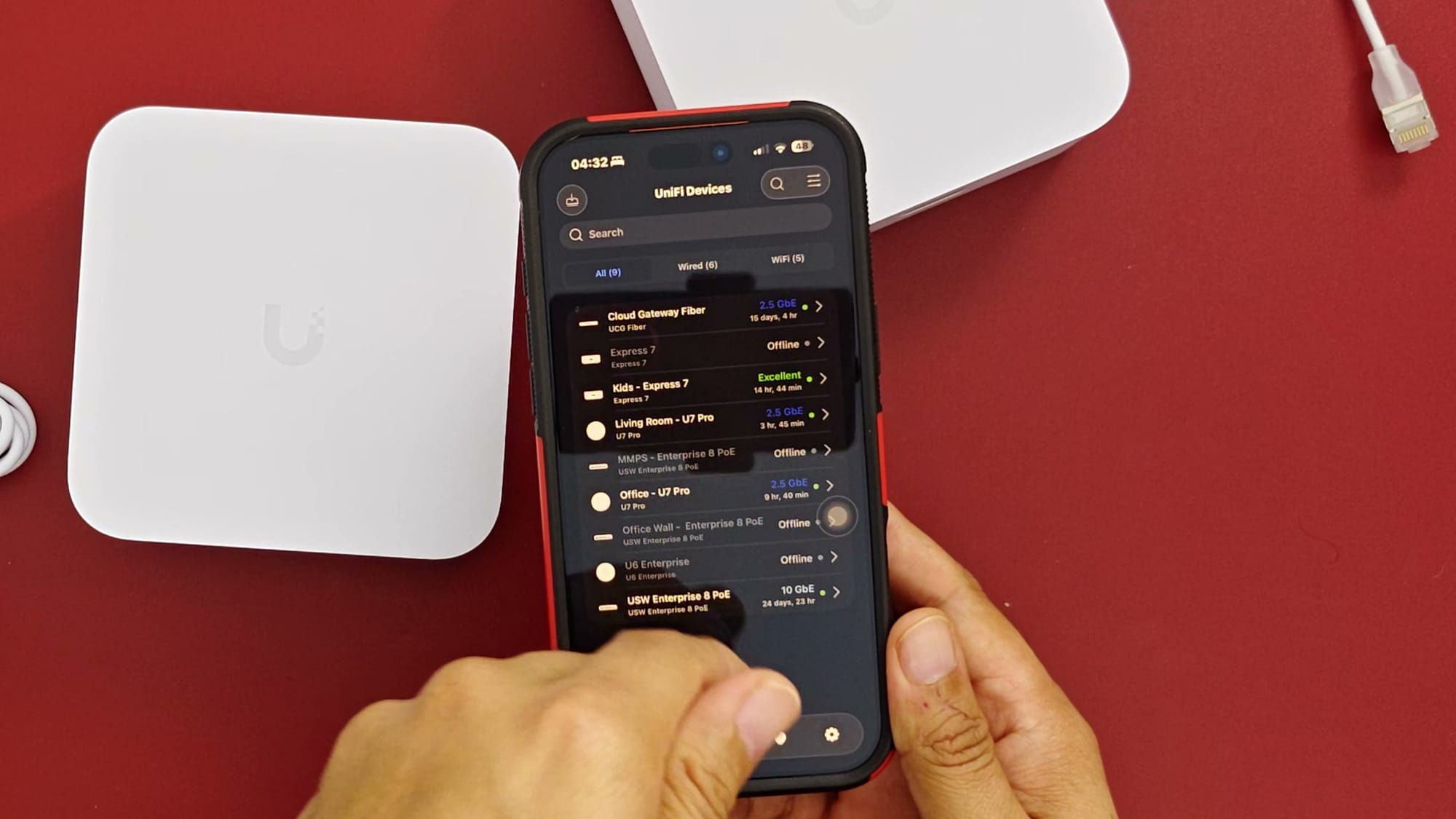 UniFi app device list on a phone next to an Express 7 unit