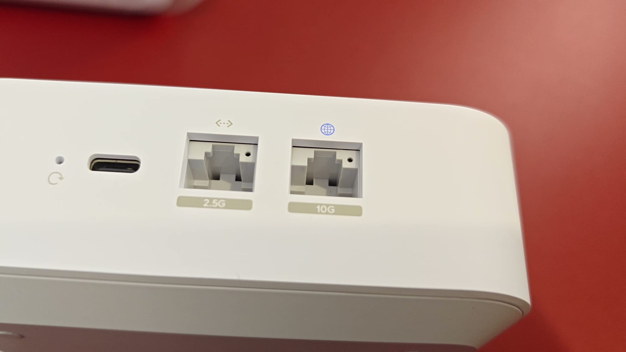 Close-up of the Express 7's reset button, USB-C power port, 2.5 GbE port and 10 GbE port