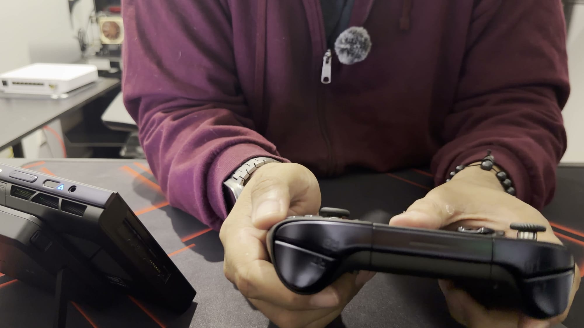The X2 Mini Pro controllers on their connector, held as a gamepad, with the screen standing beside them