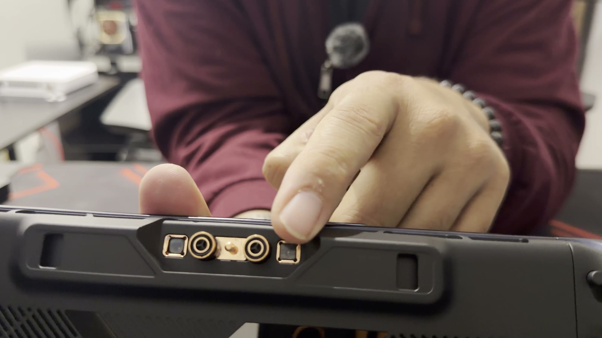 A finger pointing at the Frost Bay cooler contacts on the back of the X2 Mini Pro