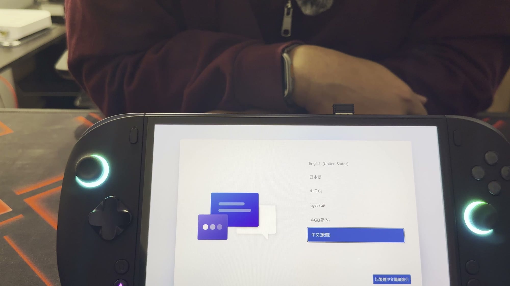 The X2 Mini Pro showing the Windows setup language screen, its stick rings lit