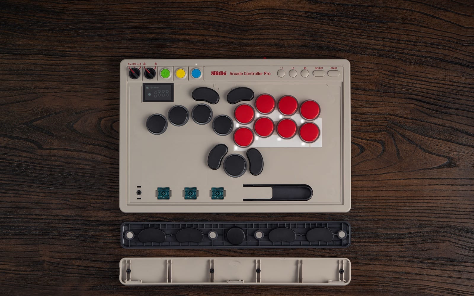 The Arcade Controller Pro with its faceplate removed, showing the stored spare switches and switch puller