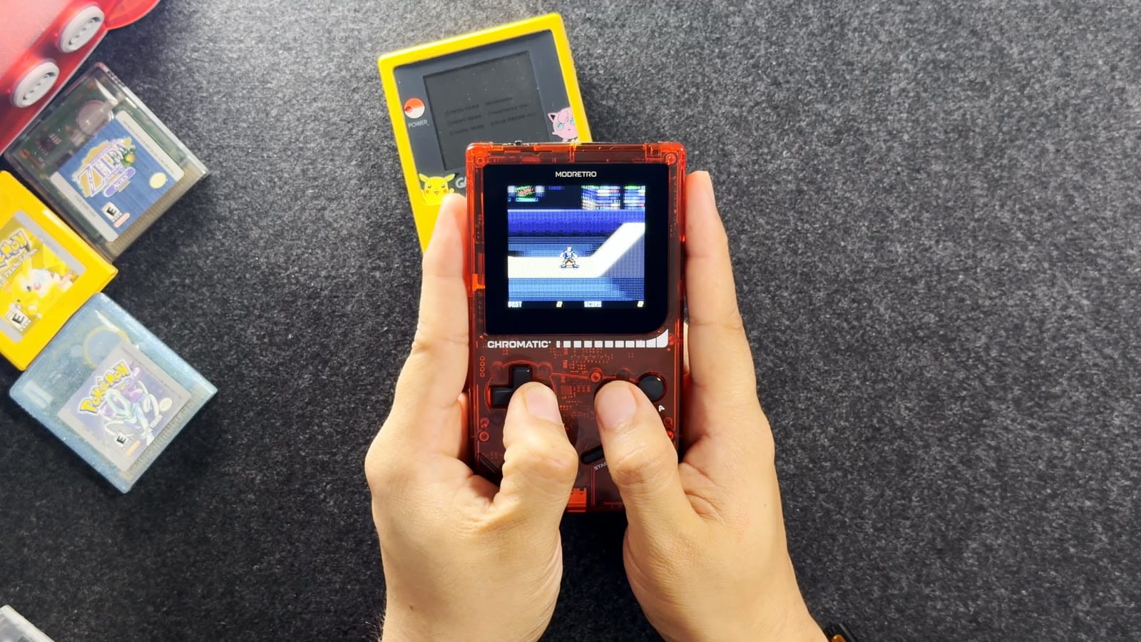 Playing Tony Hawk’s Pro Skater on the transparent red Chromatic, with a Game Boy Color and cartridges in the background