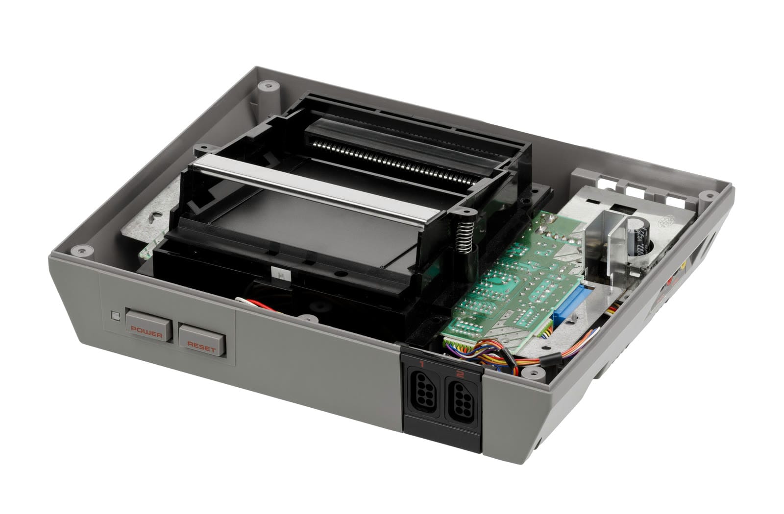NES console opened, showing the front-loading cartridge slot mechanism