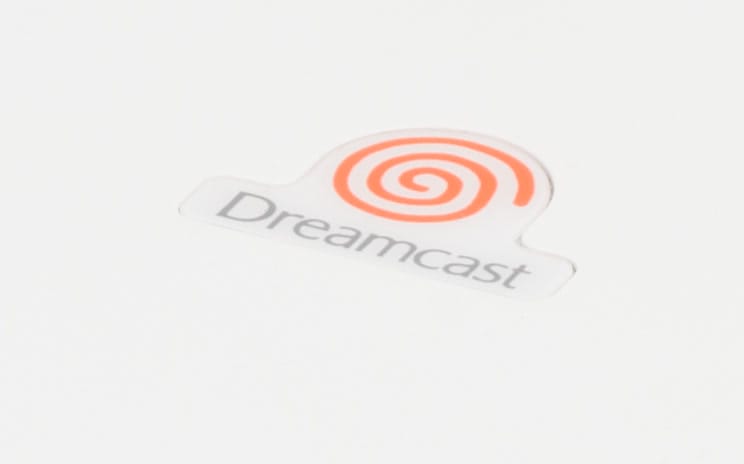 The orange Dreamcast swirl logo on the console lid