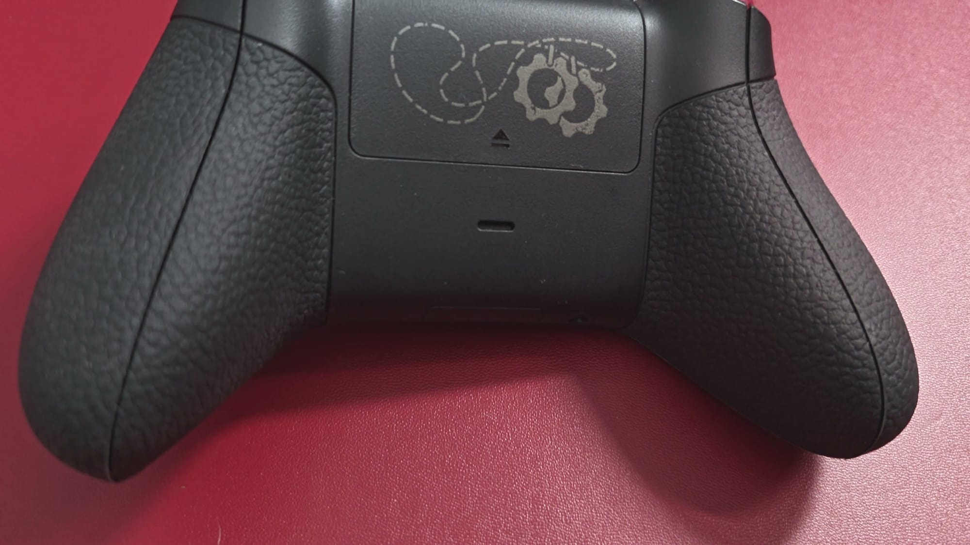 Back of the controller with rubberized grips and the COG tag etched on the battery door