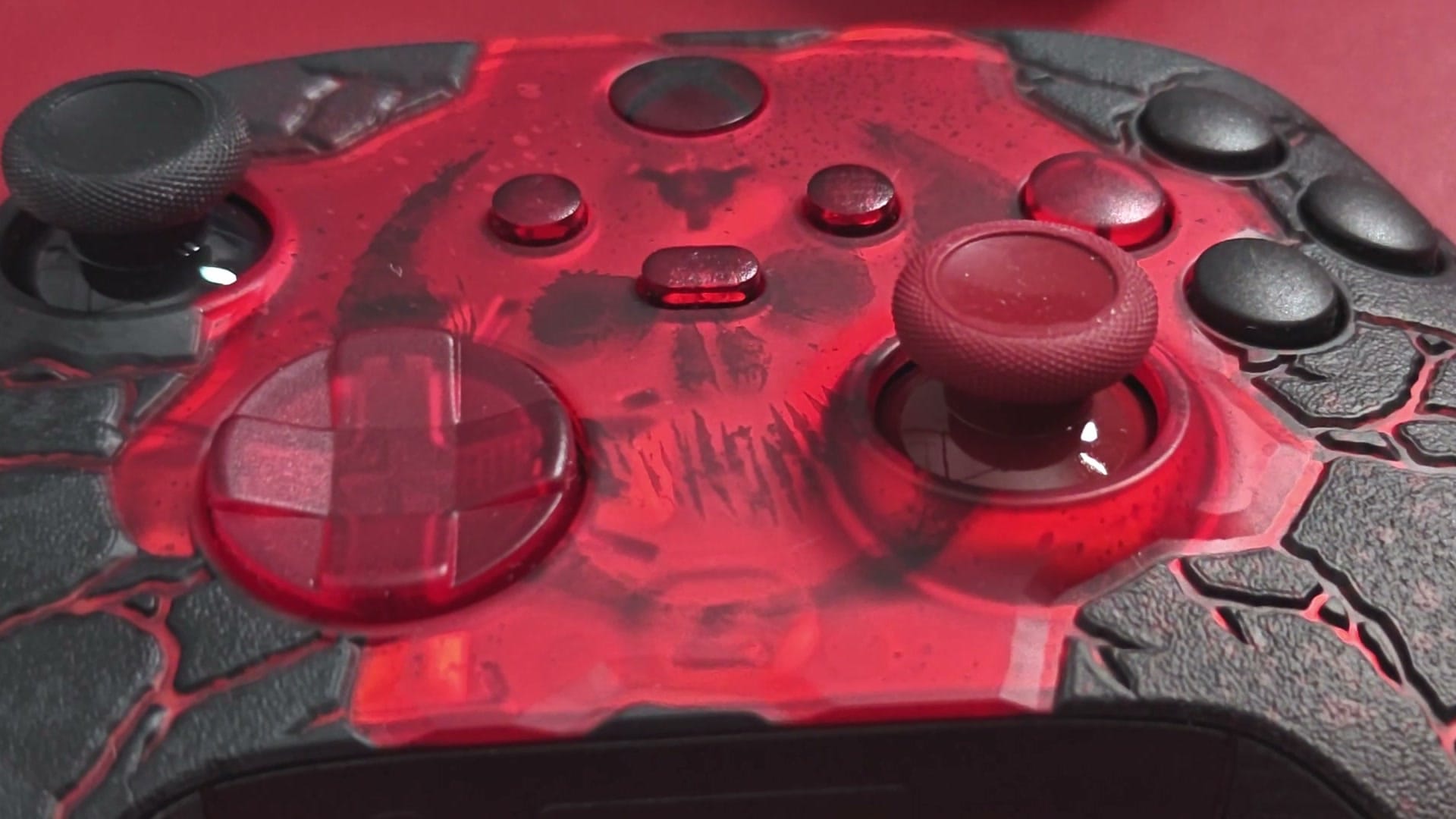 Close-up of the translucent red front of the Gears of War E-Day controller with its buttons and sticks