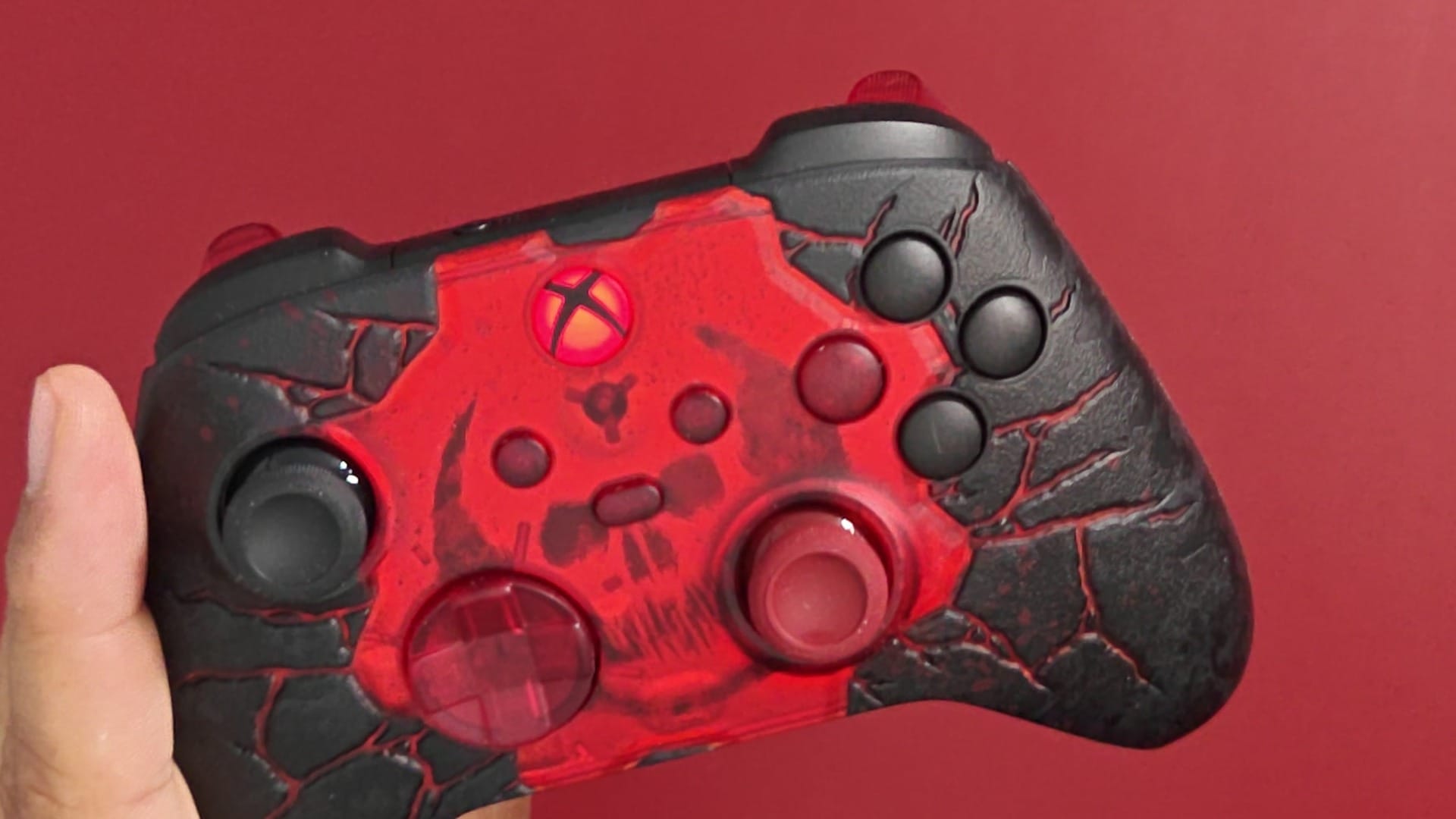 The Gears of War E-Day controller with its Xbox button glowing crimson red