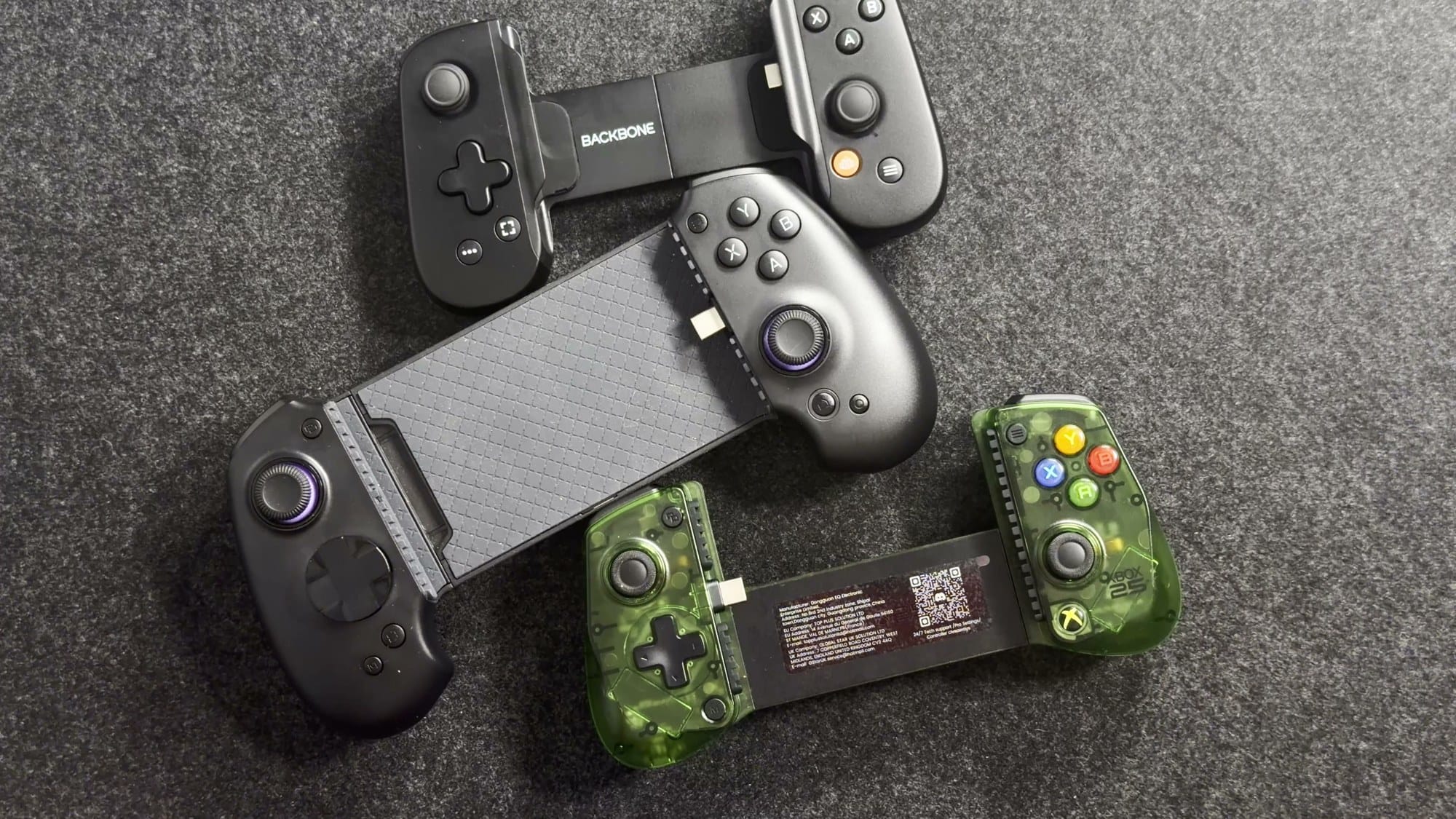 The abxylute S9, Backbone One and GameSir X5 Lite for XBOX side by side on a desk