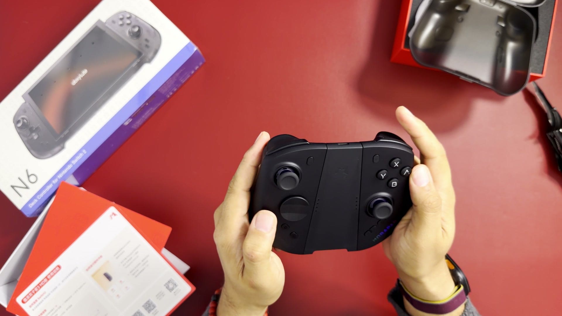 The black Mobapad M12 HD controllers joined in their charging grip