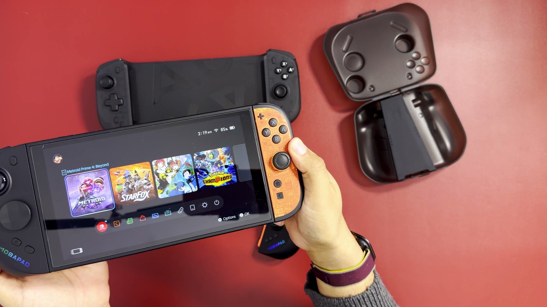 A Mobapad M12 HD half next to a Nintendo Switch 2 Joy-Con for comparison