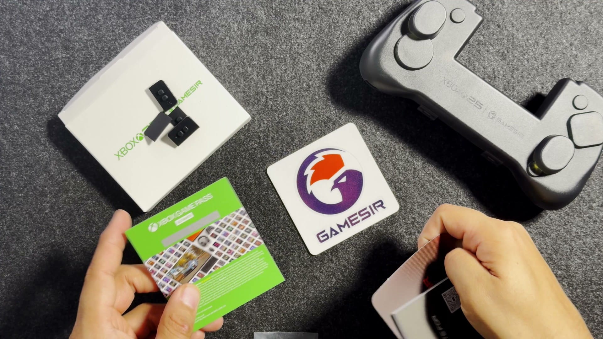 The Xbox Game Pass card, a GameSir sticker and the grey storage case from the X5 Lite box