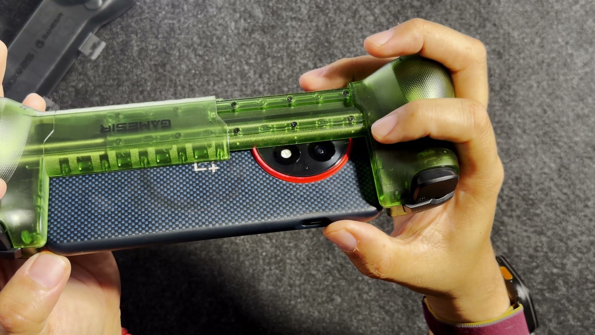 The back of an Android phone in its case inside the X5 Lite, with the camera bump clear of the rails