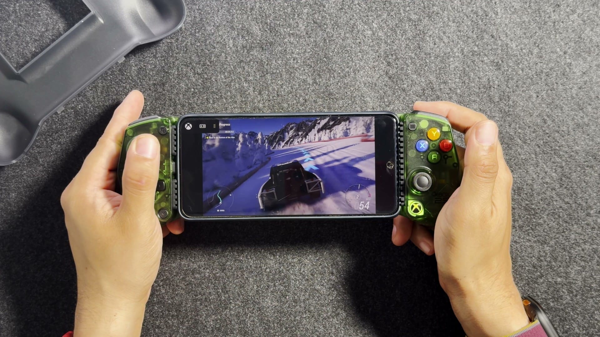 A racing game on an Android phone held in the X5 Lite