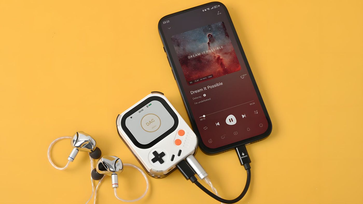 A white Hidizs AP30 Music Boy connected to a phone and in-ear headphones on a yellow background