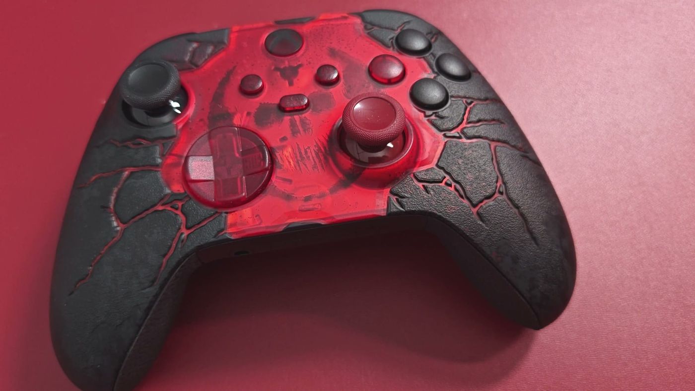 Close-up of the Gears of War E-Day Xbox controller with its translucent red front and cracked black shell