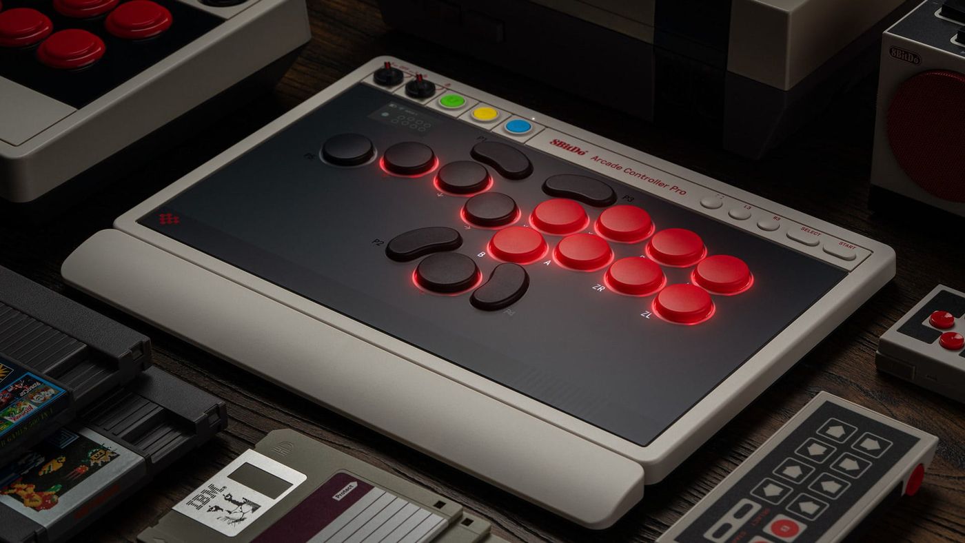 The 8BitDo Arcade Controller Pro N Edition lit up on a desk with its wrist rest attached
