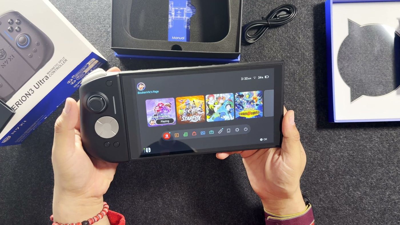 The black NYXI Hyperion 3 Ultra controllers attached to a Nintendo Switch 2 showing its home screen