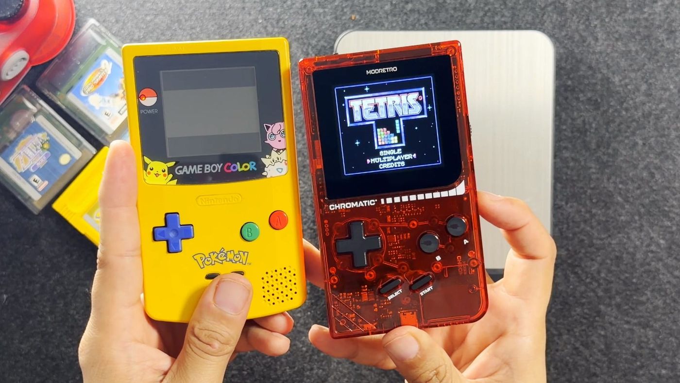 My yellow Pikachu edition Game Boy Color and the transparent red ModRetro Chromatic held side by side, the Chromatic showing the Tetris title screen