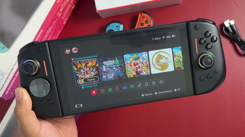 NYXI Hyperion 3 controllers attached to a Nintendo Switch 2, showing the home screen, held over a red mat