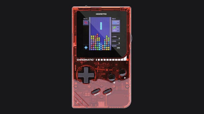 The transparent red ModRetro Chromatic handheld running Tetris, on a dark background