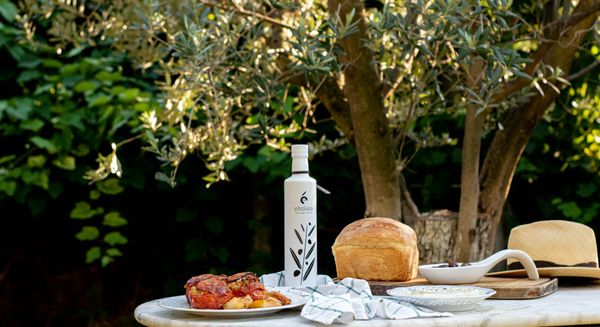 A Mediterranean summer table set with bread and olive oil