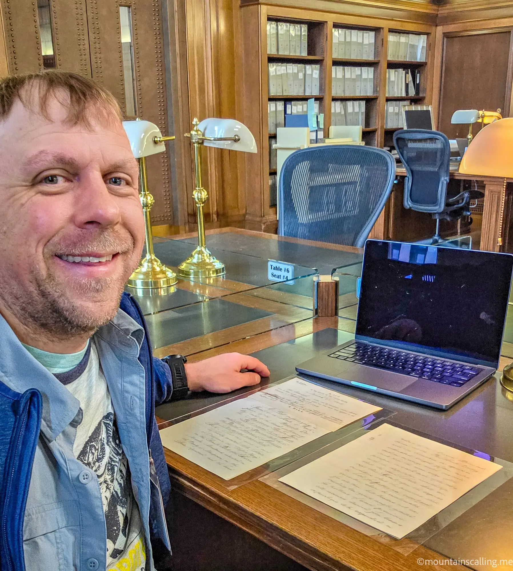 Eric Kufrin studying original Yosemite Grant documents at National Archives research room with historic papers and laptop