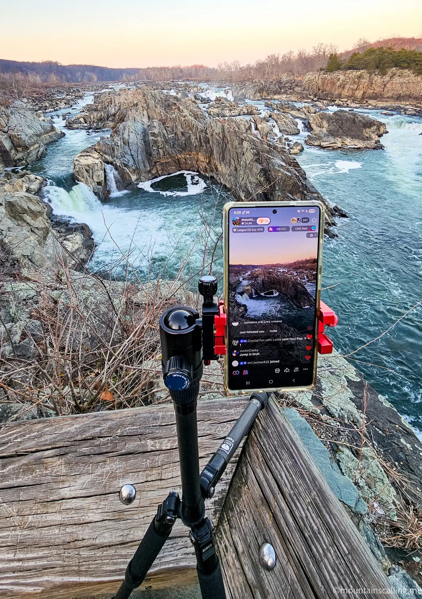 Smartphone mounted on tripod livestreaming waterfalls at Great Falls Park, Virginia during golden hour sunset