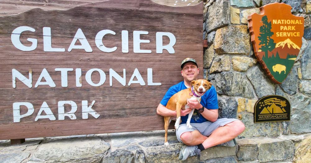 Eric Kufrin and his dog Kali posing at the Glacier National Park entrance sign with National Park Service arrowhead emblem