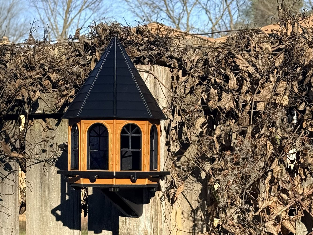 3D printed birdhouse mounted outdoors on fence post