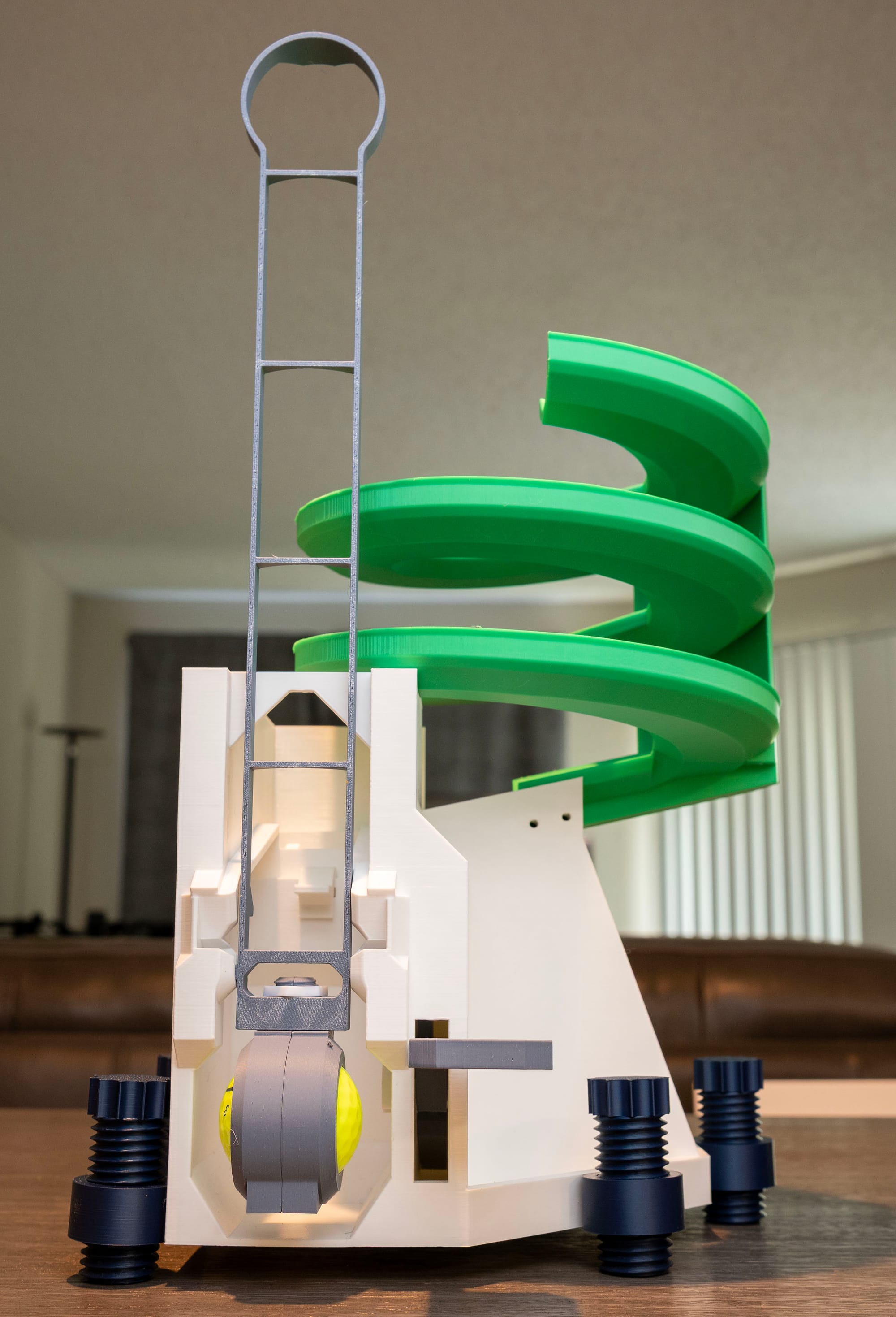 Hybrid PLA and PETG golf ball dispenser with upgraded PETG ramp, swing arm, and foot pedal.