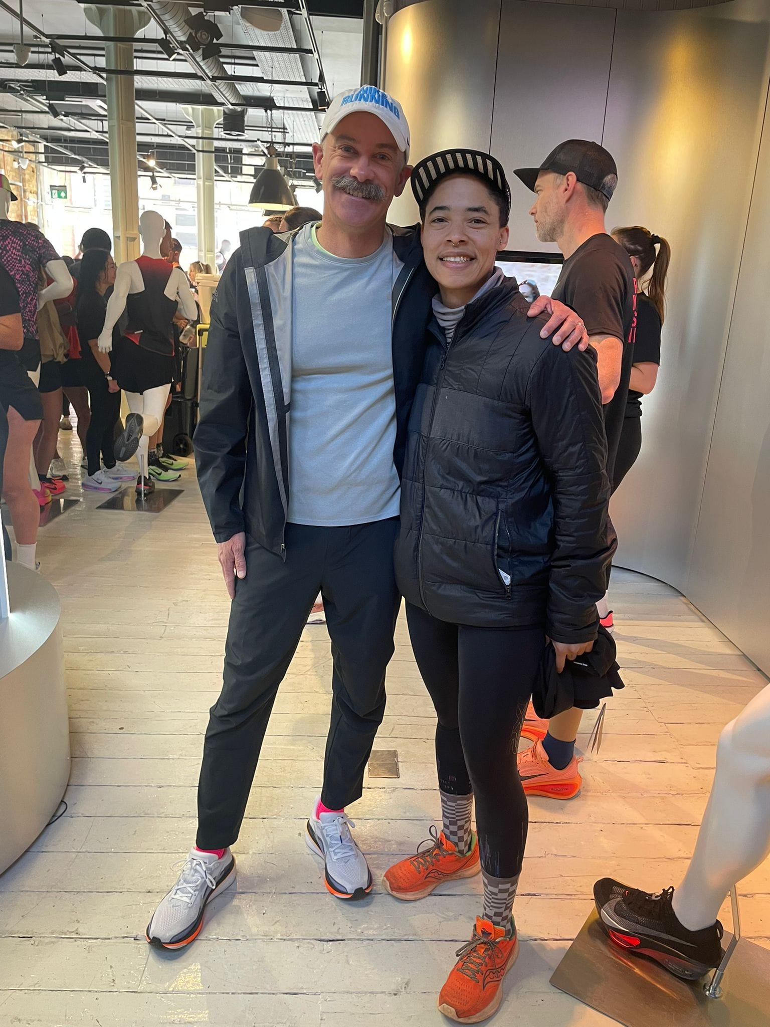 c. l. clark and coach bennett standing side by side in a sport shoes shop.