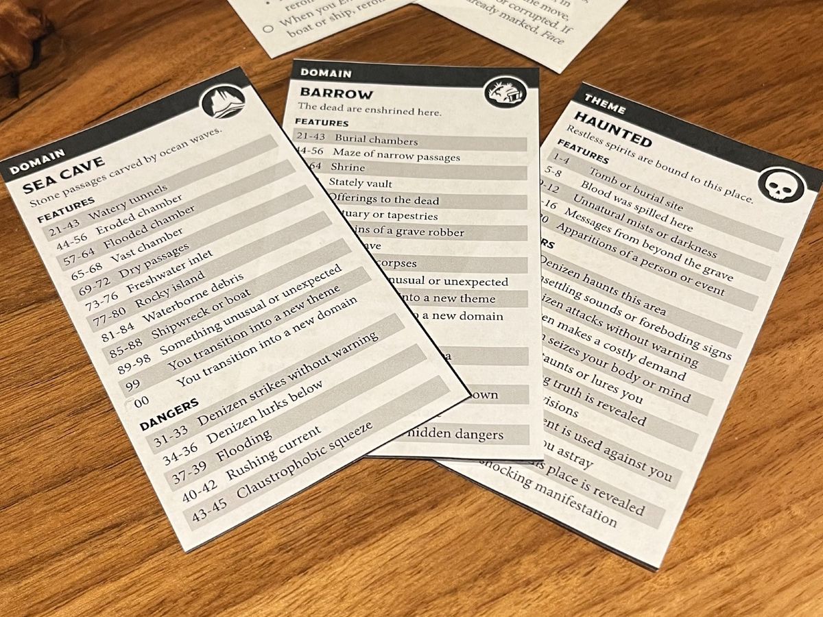 two domain cards and one theme card from ironsworn: delve. they depict a sea cave that is also a series of barrows that are haunted.