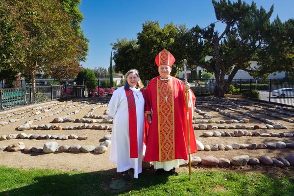 A photo of Mother Kellie Grace and Bishop John H. Taylor standing in front of the church's new labyrinth.