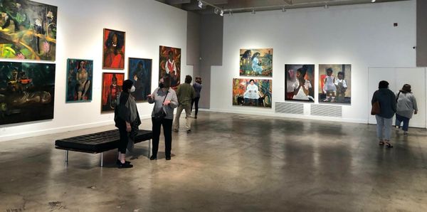 A photo of attendees at an evening art exhibit at the RAM
