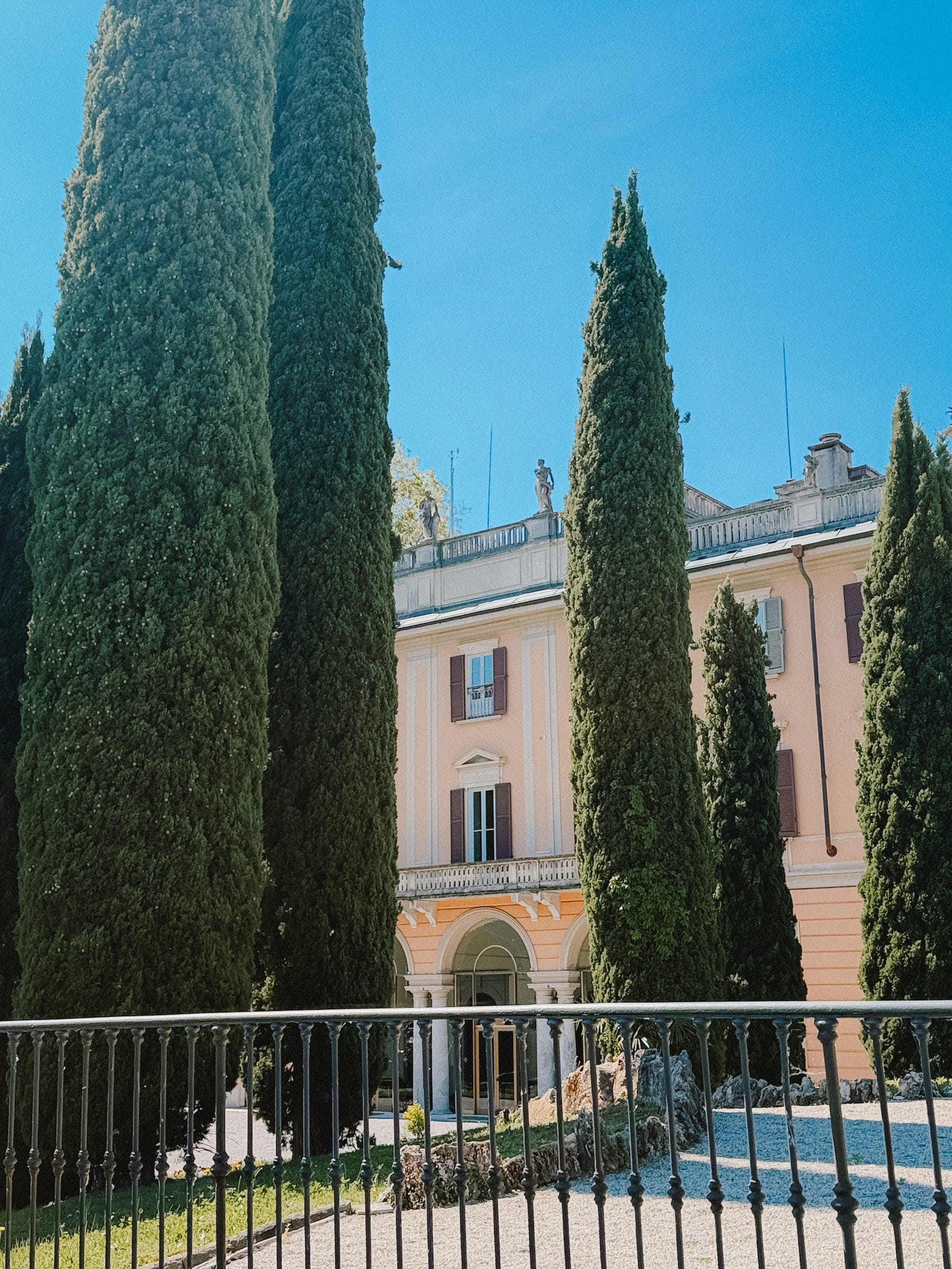 A villa behind cypresses
