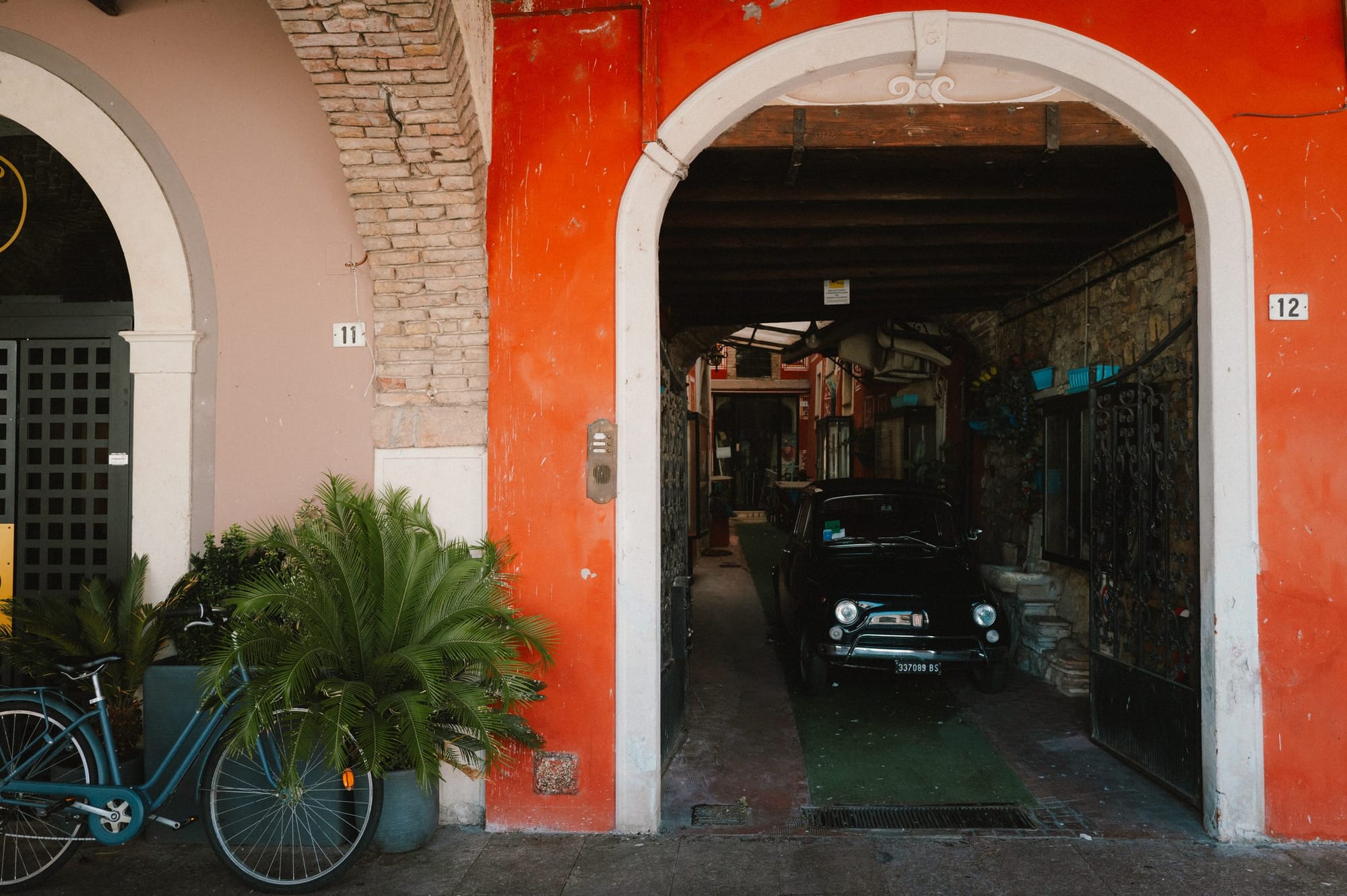 A red archway and a parked car