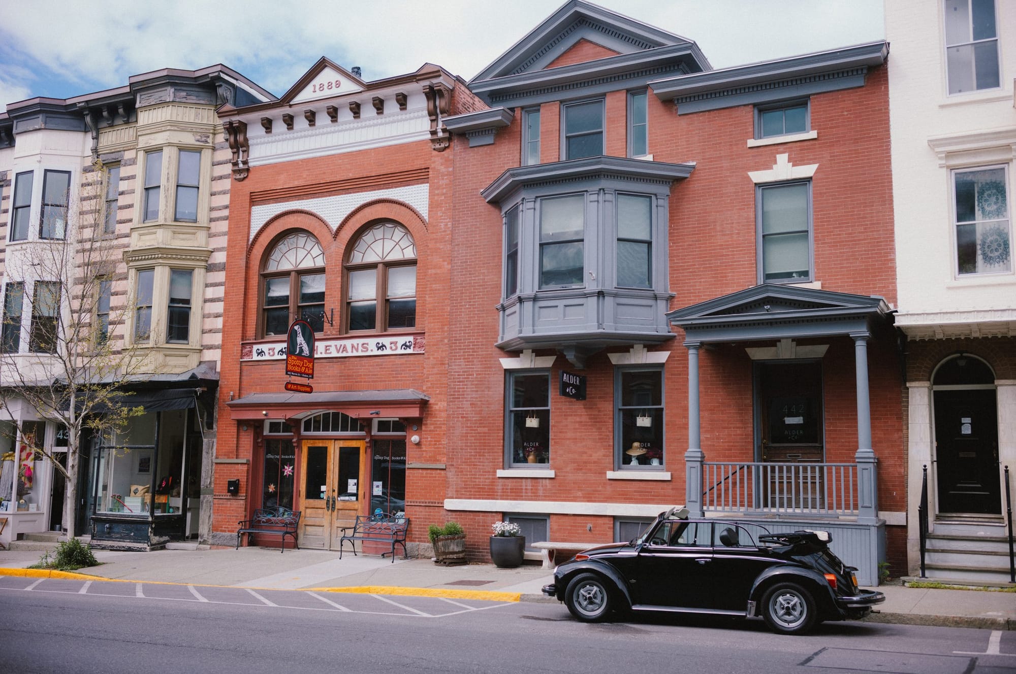 A brick main street and a black convertible