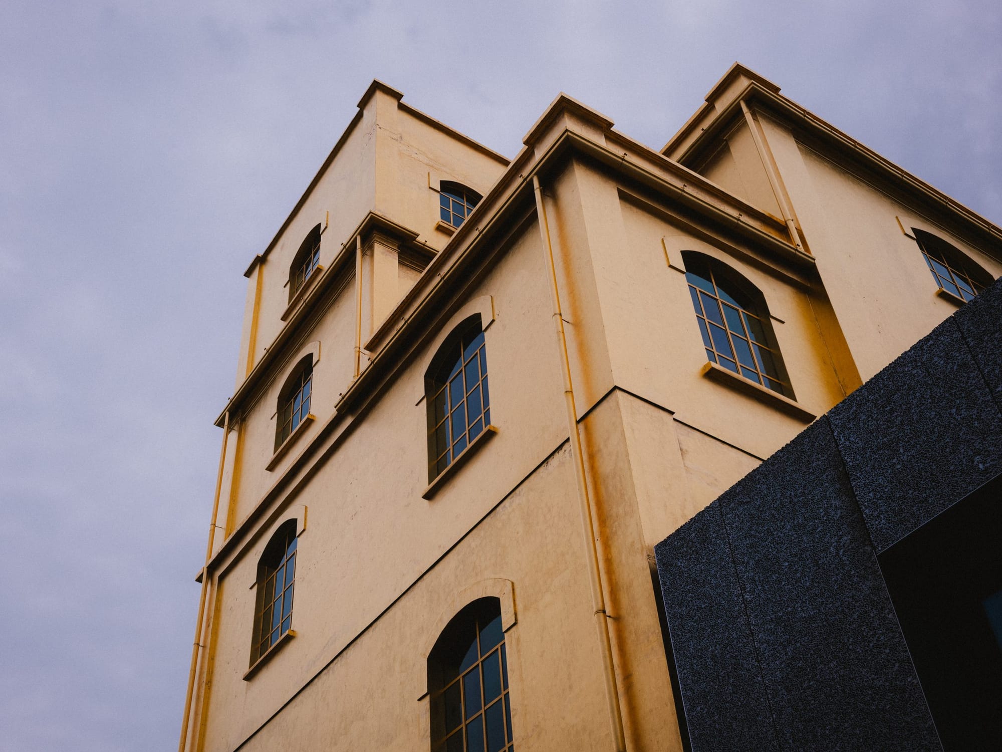 A gilded tower against a grey sky