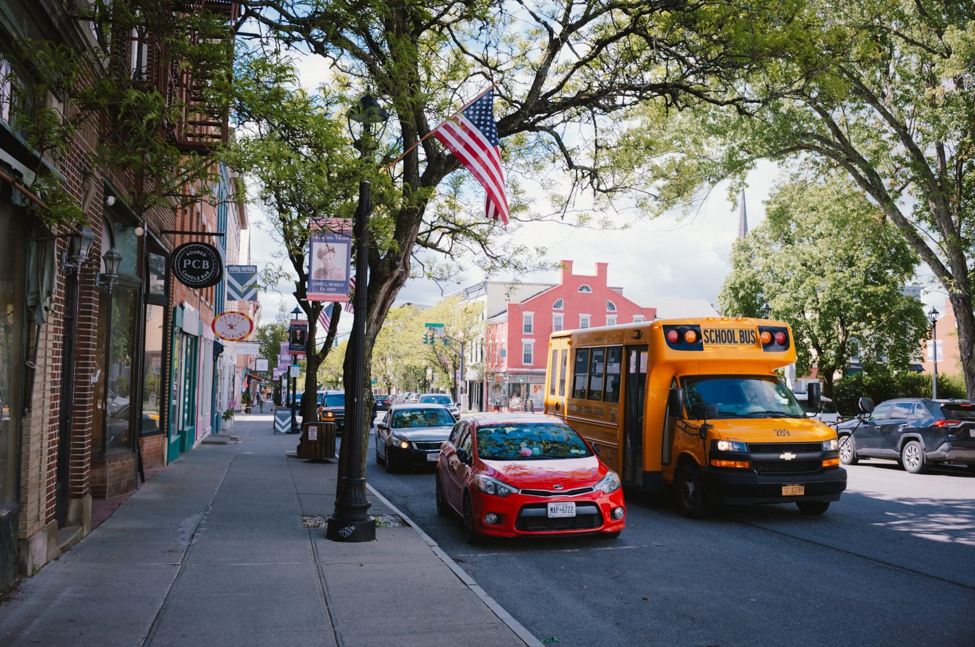 A main street with a yellow school bus