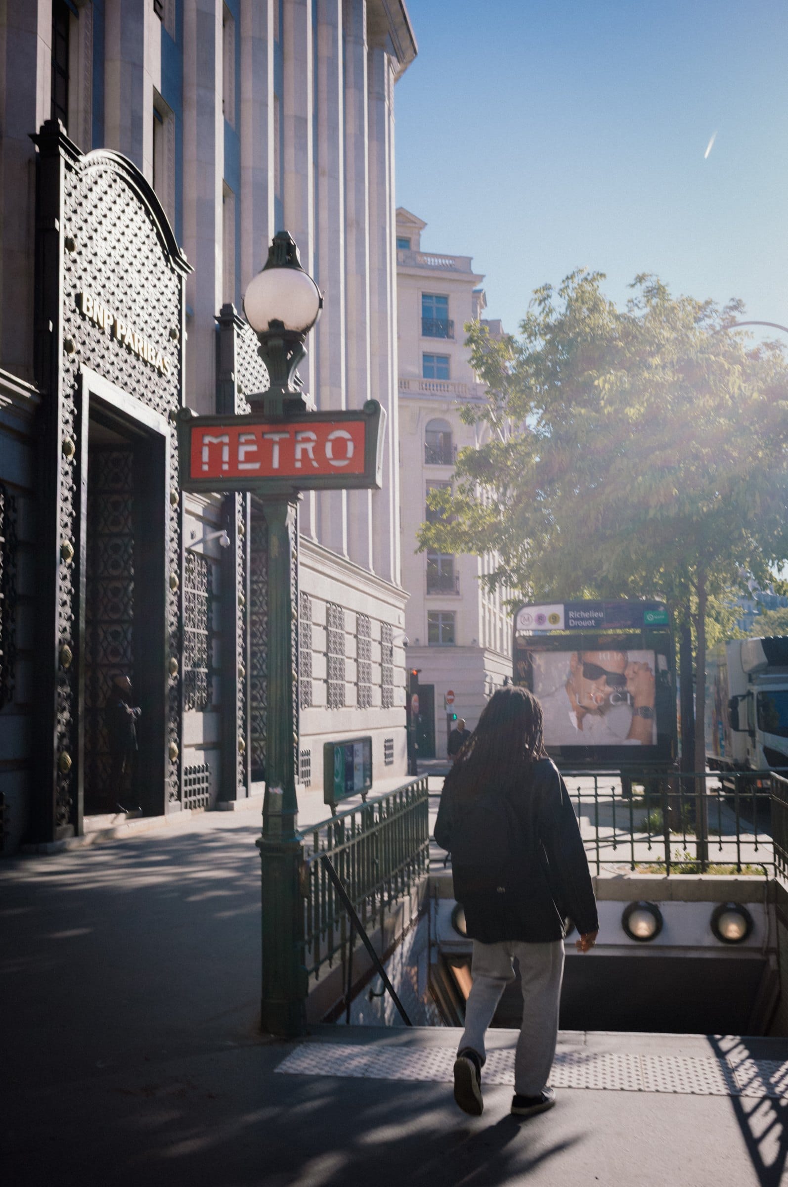 A corner, a Métro sign, and the first light of the morning.