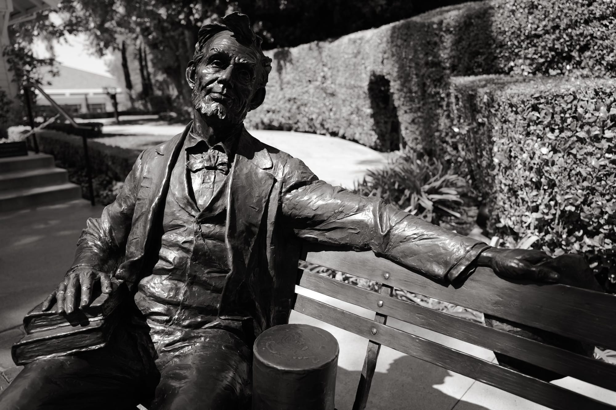 Bronze, on a bench.