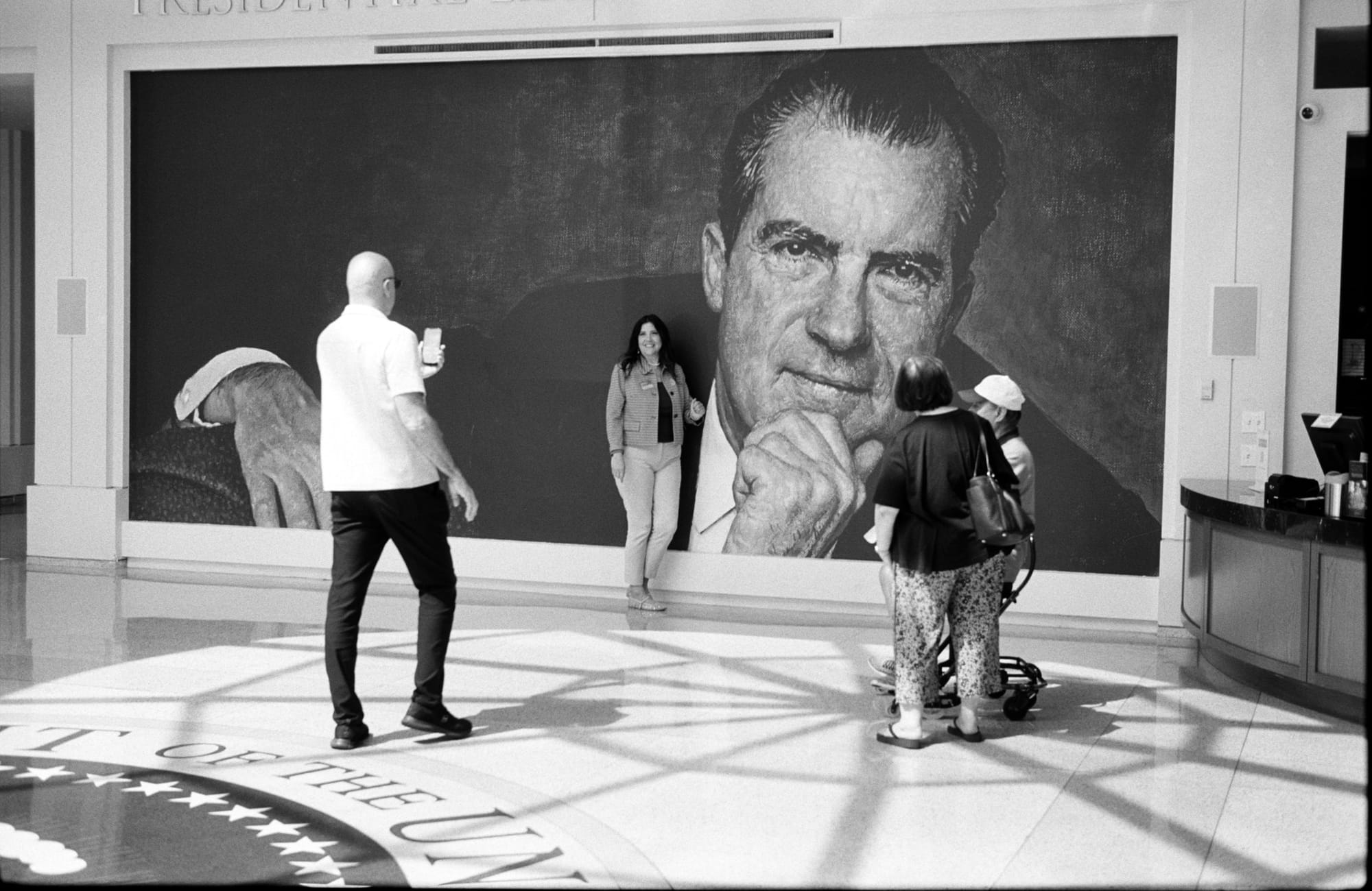 On film: visitors under the portrait in the lobby.